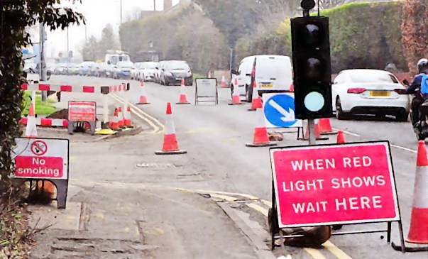 Completely fucking useless signs which achieve nothing but the creation of entirely unnecessary traffic jams, installed by Roadwork Cunts