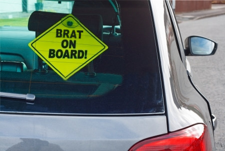 Brat On Board sign in car window