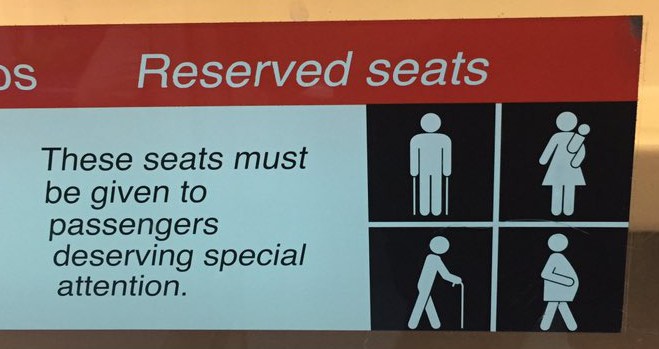 Sign: please give these seats to special passengers (left, with sticks; right, with kids)